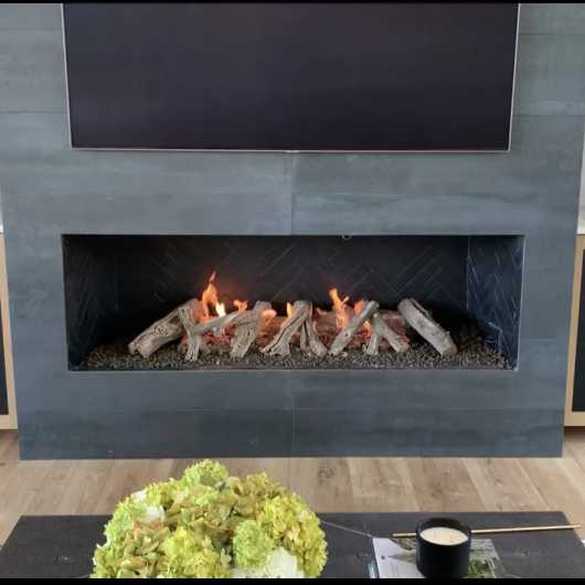 gas fireplace with custom surround and drift wood log set